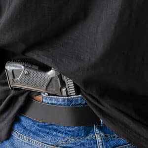 Hand gun hidden in man's waistbelt
