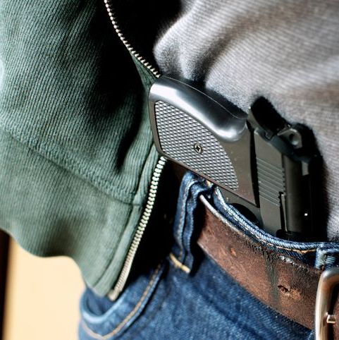 Tucked in a belt pistol being concealed
