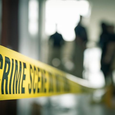 crime scene tape with blurred forensic