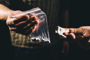 Cash being offered for a bag of drugs