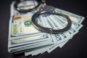 $100 banknotes and handcuffs