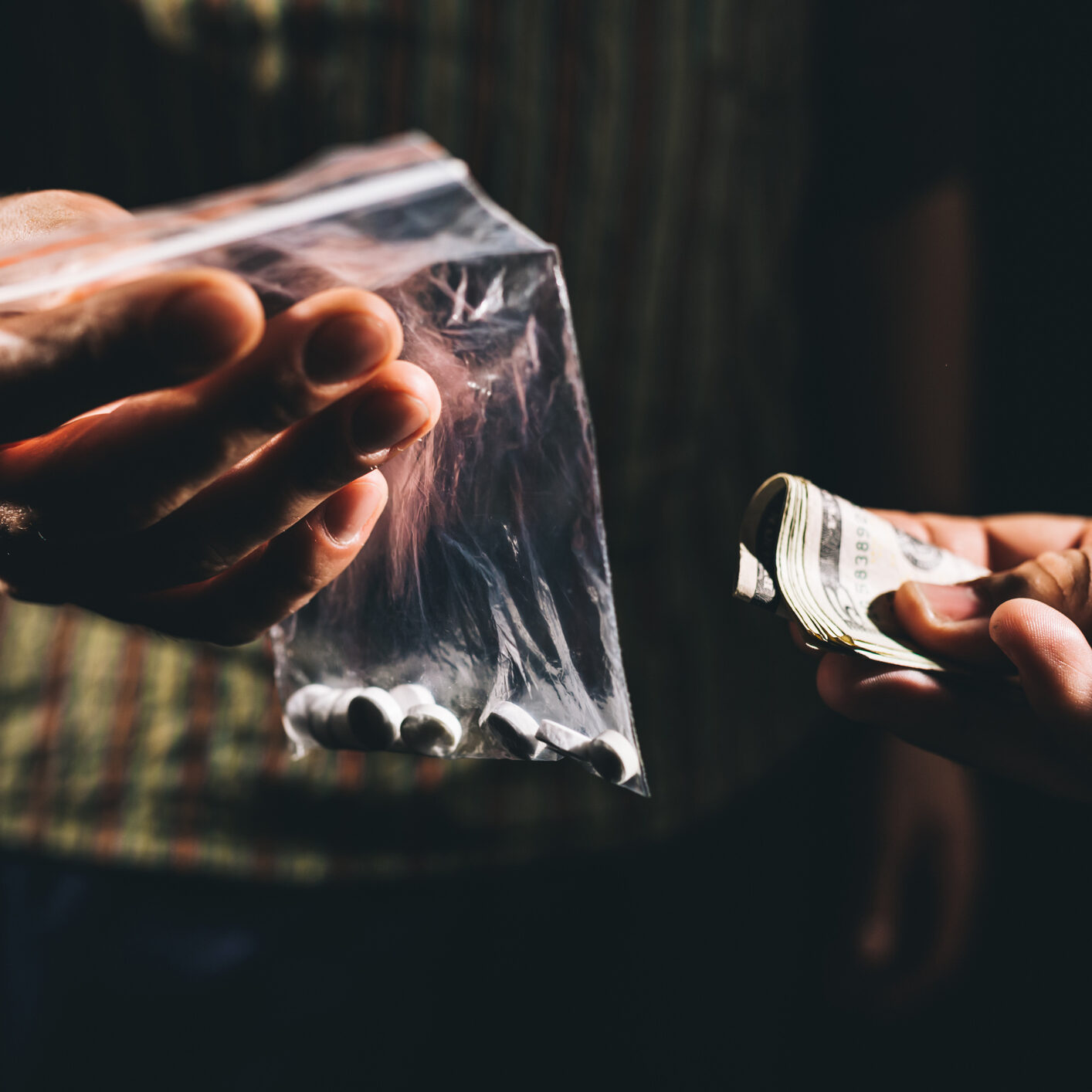 Cash being offered for a bag of drugs