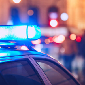 Police car on a busy street with its lights on